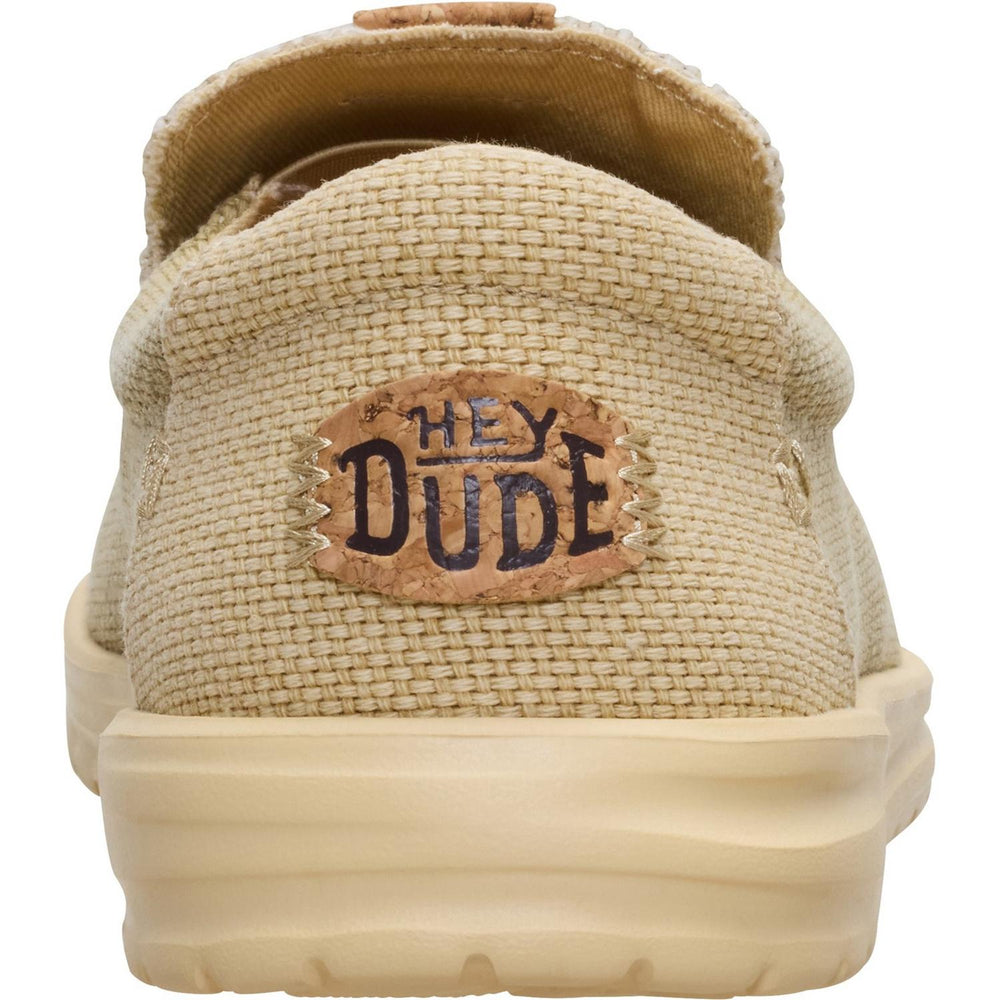Close-up of the HEYDUDE Mikka heel, showing the leather HEY DUDE patch and the thick cushioned sole