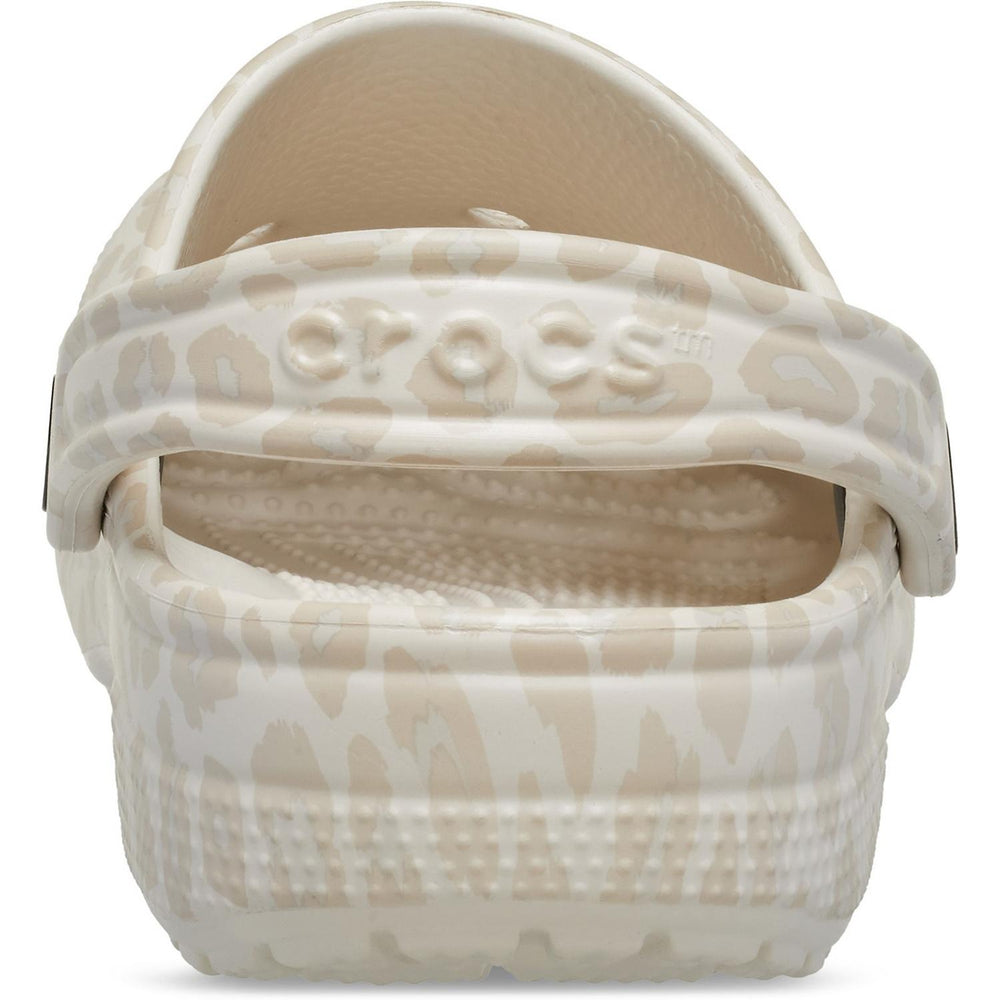 Rear close-up of the cream leopard-print Crocs clog, showing the crocs wordmark on the printed heel strap