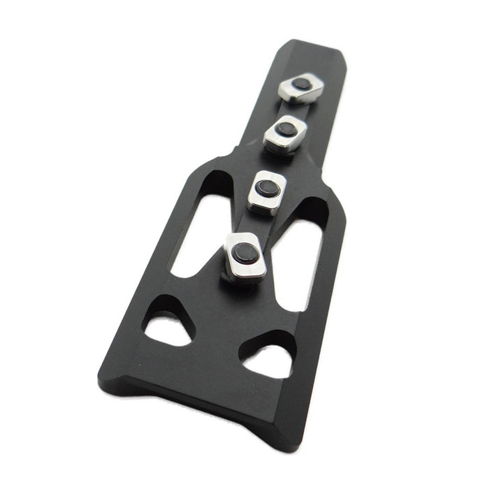 Nieload ARCA/Picatinny M-LOK adaptor viewed from above, showing the lightening cut-outs and four silver M-LOK fixing nuts