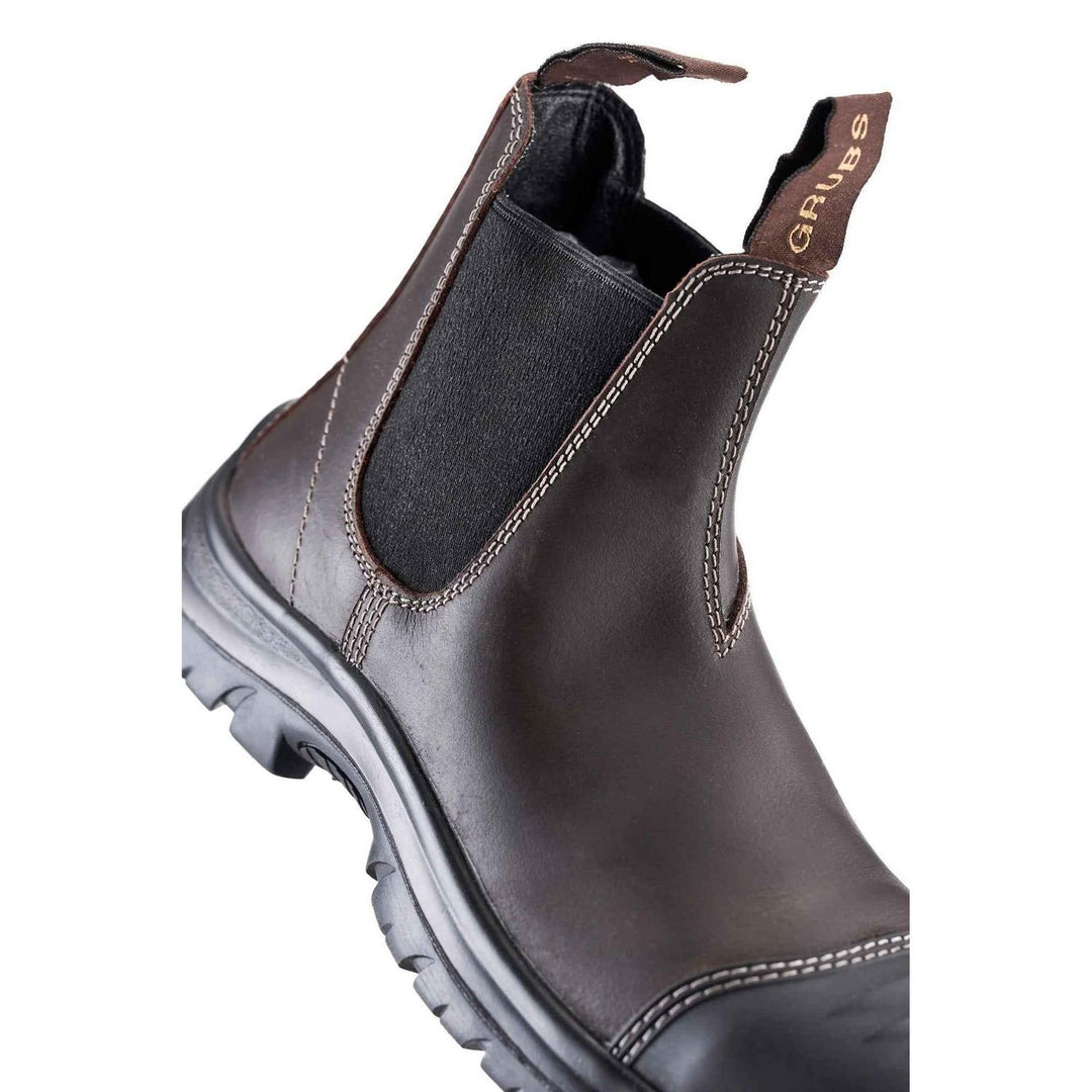Grubs Tornado S3 SRC dealer boot in brown leather, close three-quarter view of the elastic gusset, pull tab and chunky sole