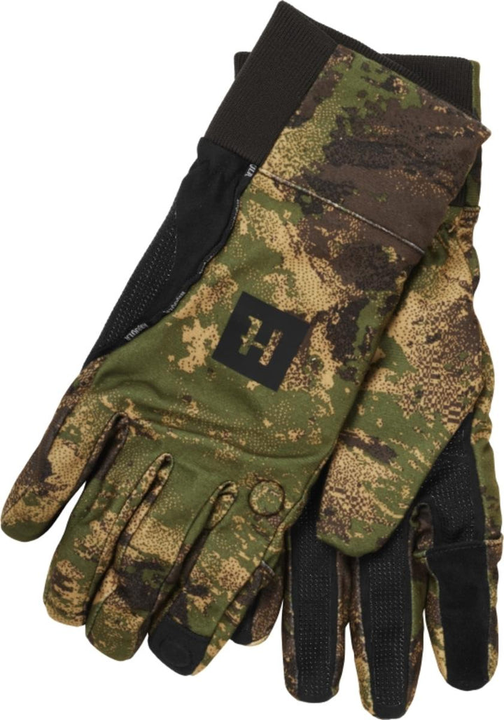 Harkila Deer Stalker Camo HWS gloves in AXIS MSP Forest green camouflage with black palms and a black H logo tab, pair shown overlapped on grey.