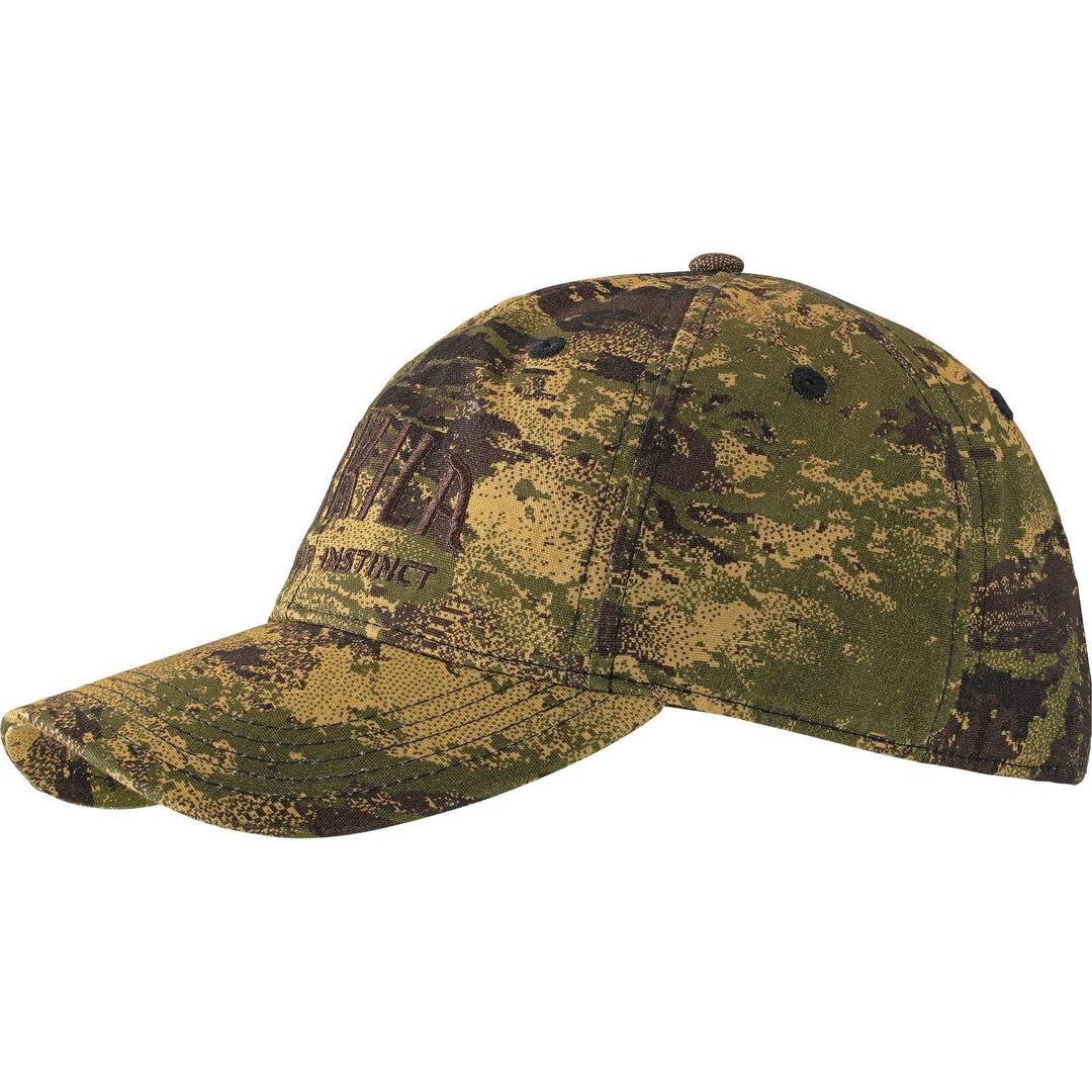 Härkila Modi camo cap in AXIS MSP Forest pattern, side view with 'Instinct' embroidered on the front panel