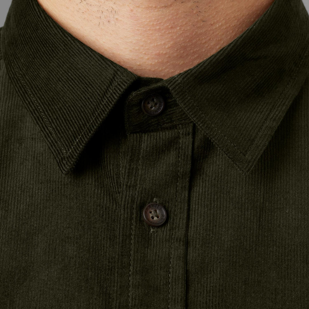 Extreme close-up of the Kaldfjord shirt collar and top buttons as worn, showing the fine corduroy wale and the dark tonal buttons.