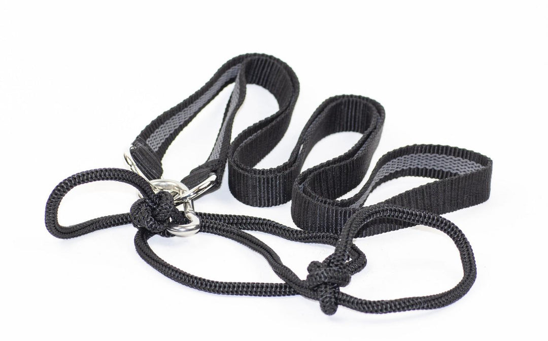 Mjoelner deer carrying strap and drag line, black webbing loops and cord with metal sliders, laid out coiled on white