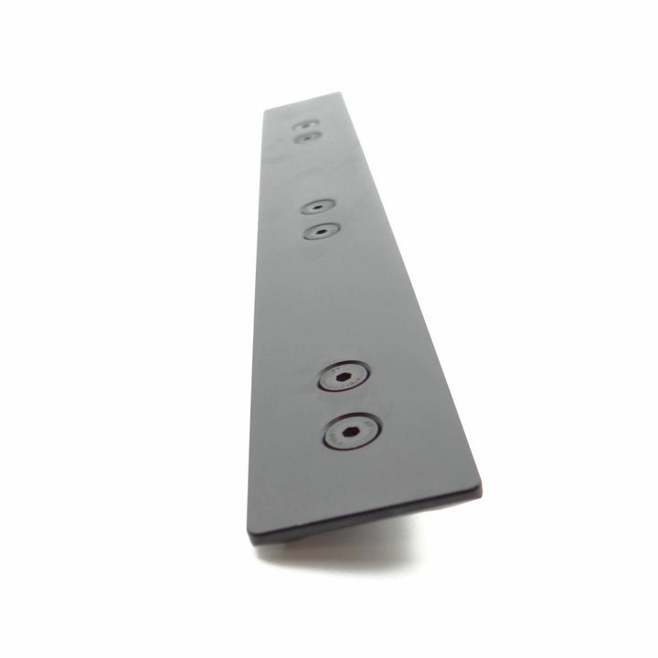 Nieload ARCA forend rail shown at a steep angle from the underside, black bar with countersunk mounting holes