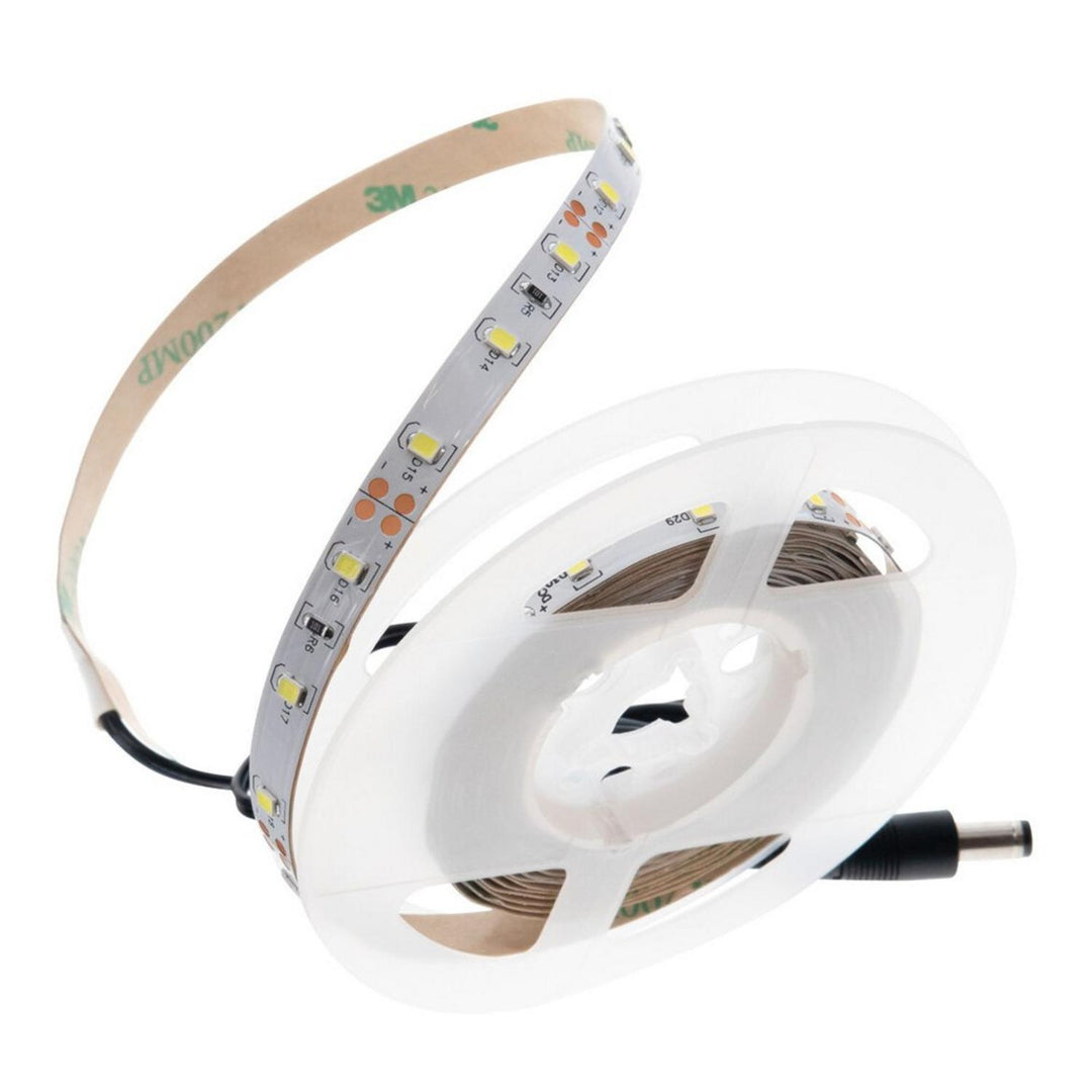 Lockdown LED vault tape light, a reel of white LED strip partly unwound to show the adhesive backing, with a DC barrel plug lead