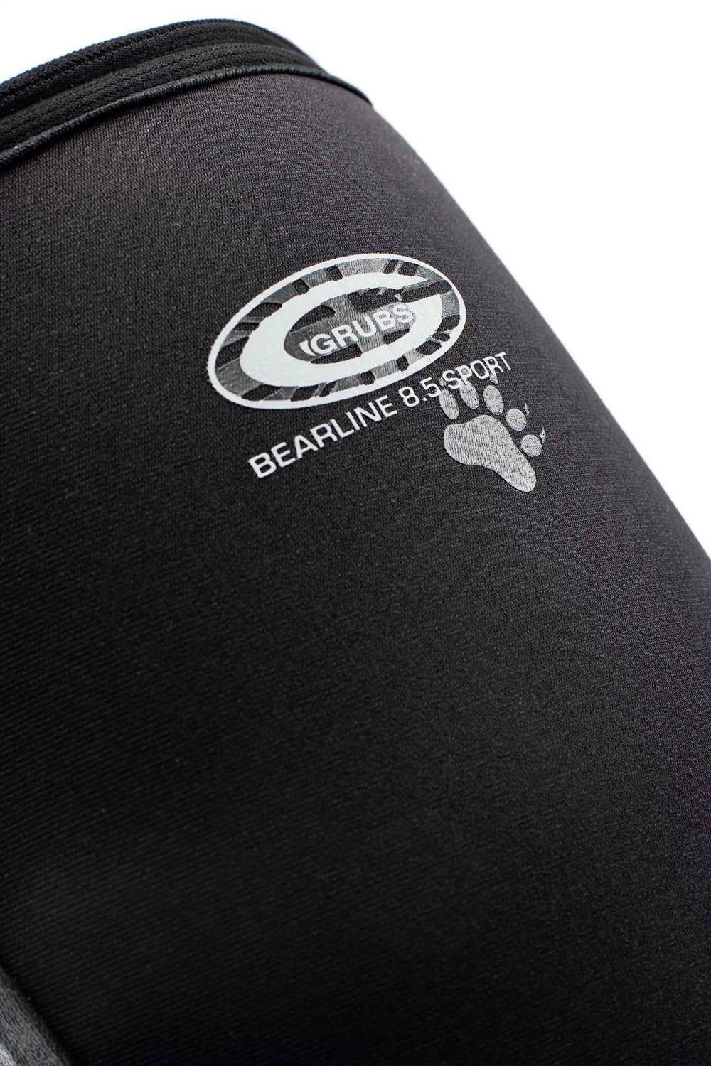 Close-up of the Grubs Bearline 8.5 Sport logo and paw print on the black neoprene shaft of the boot
