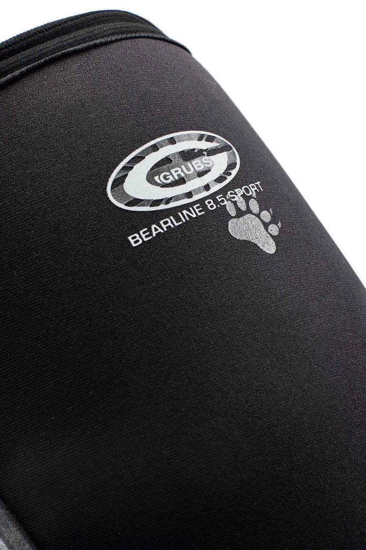 Close-up of the Grubs Bearline 8.5 Sport logo and paw print on the black neoprene shaft of the boot