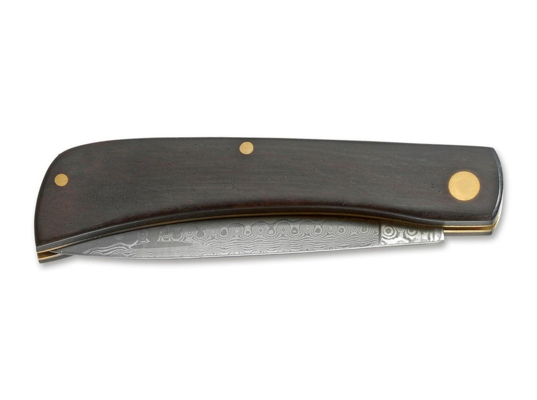 Böker Magnum Ebony Rangebuster Damascus folding knife closed, ebony handle with brass pins and Damascus blade edge, side view