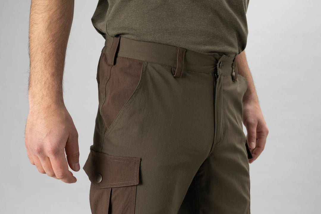 Model wearing the Seeland Birch trousers, close crop of the hip and thigh showing the flapped cargo pocket, belt loops and waistband