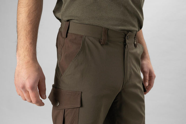 Model wearing the Seeland Birch trousers, close crop of the hip and thigh showing the flapped cargo pocket, belt loops and waistband