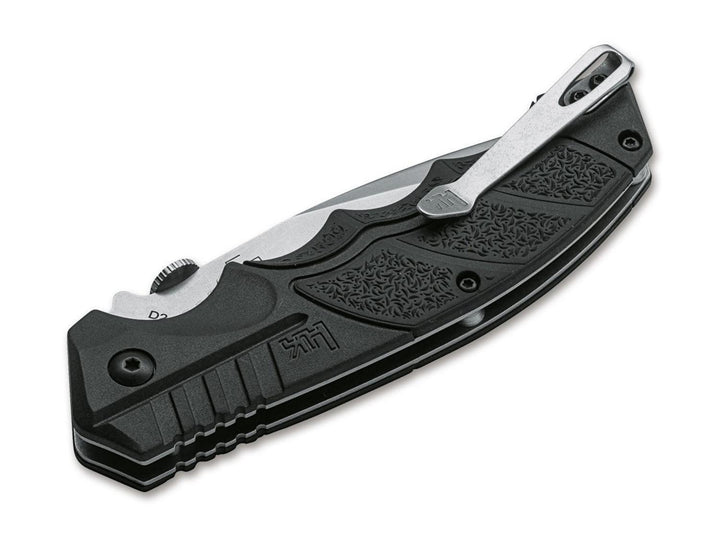 Böker SFP Tactical folding knife closed, black textured handle with pocket clip and H&K logo, angled view