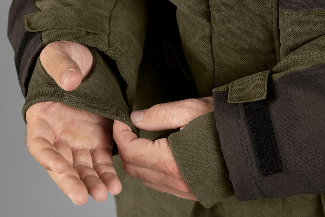 Close-up of hands fastening the adjustable cuff tab on the Seeland Taiga jacket
