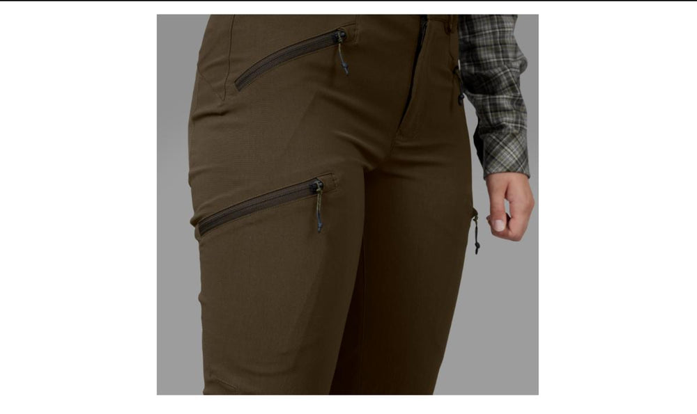 Close-up of the Seeland Larch women's trousers hip, showing the zipped hand and thigh pockets, worn with a check shirt