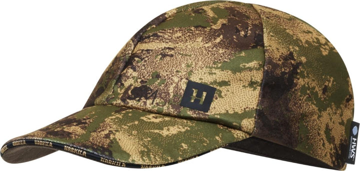 Harkila HWS deer stalker cap in AXIS MSP Forest camouflage, shown side-on with the Harkila-branded peak underside and small embroidered logo on the crown.