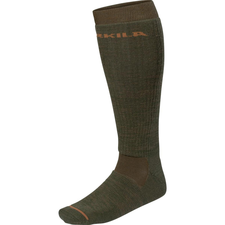 Harkila Pro Hunter 2.0 long sock in willow green with orange Harkila logo and shadow-brown heel and toe, shown side-on over a knee-height leg form