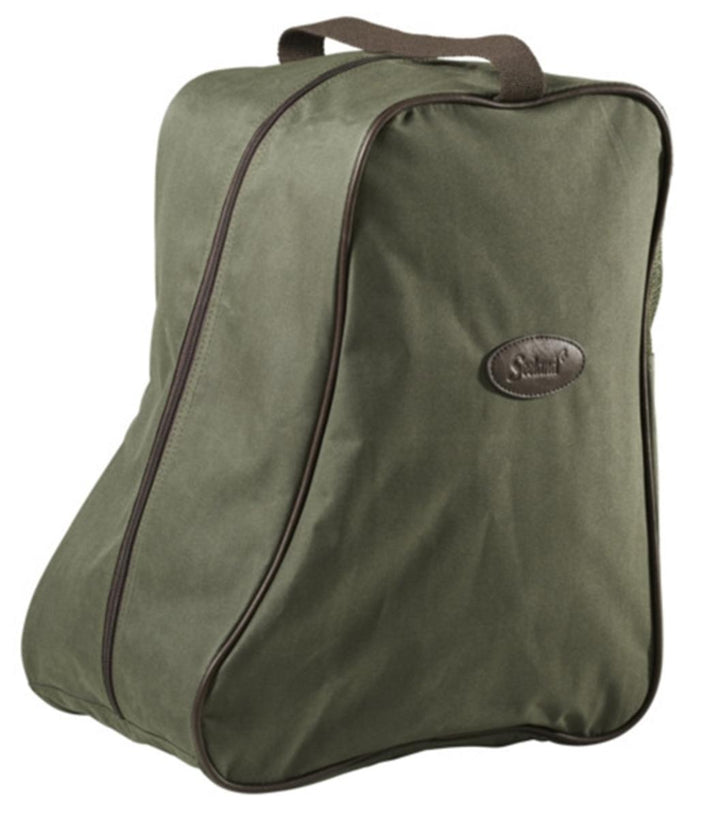 Seeland Design Line boot bag in green canvas with brown trim, three-quarter view showing the curved zip around the boot-shaped panel, a webbing carry handle and an oval leather brand badge.